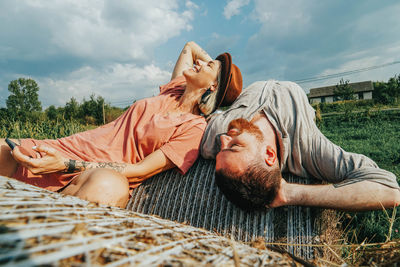 Couple relaxing on hay bales