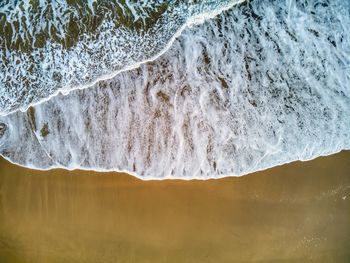 Aerial view seashore and breaking waves in asturias, spain.