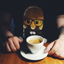 Close-up of hand holding coffee cup