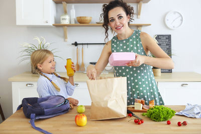 Full length of woman having food at home