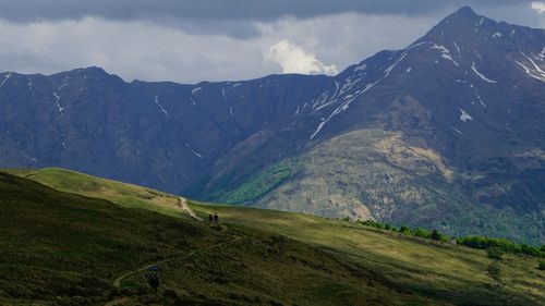 Scenic view of mountains against cloudy sky