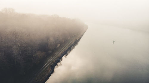 High angle view of trees by lake against sky