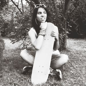 Portrait of young woman standing on grass