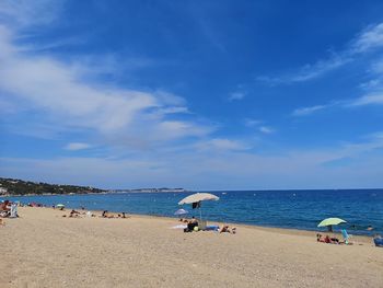 Scenic view of beach against blue sky