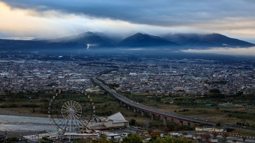 Dramatic and dark process cityscape in a strom and smog layer mountain background in japan