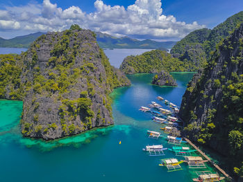 High angle view of sea and mountains against sky