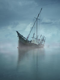 Sailboat in sea against sky