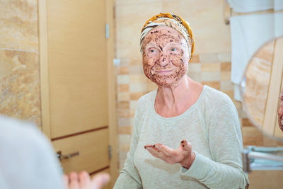 Senior woman taking care of her face