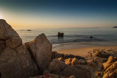 Scenic view of sea against clear sky during sunset