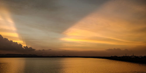 Scenic view of dramatic sky over sea during sunset