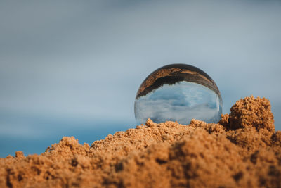 Low angle view of sand on beach against sky