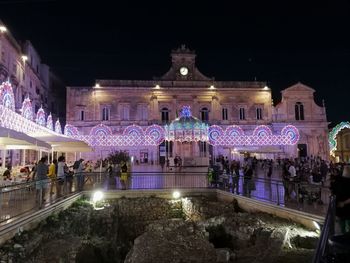 Group of people in illuminated building at night