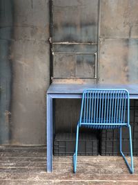 Empty chairs against wall in old building
