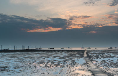 Scenic view of boats in sea against sky during sunset