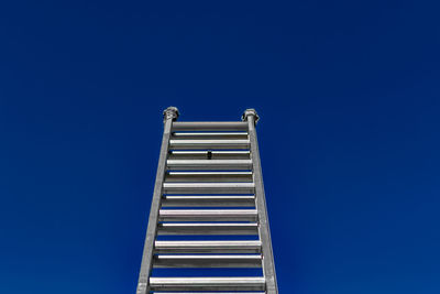 Low angle view of built structure against clear blue sky