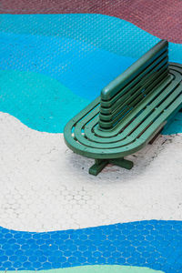 High angle view of empty chairs by swimming pool