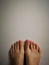 Low section of woman legs against white background