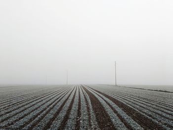 Scenic view of field against sky during winter