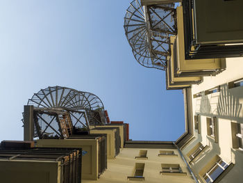 Low angle view of balconies against blue sky