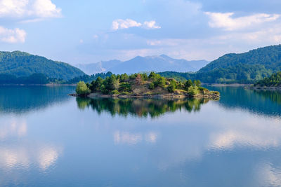 Scenic view of lake and mountains against sky