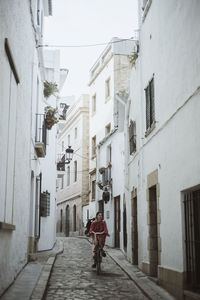 Rear view of woman walking on street in city