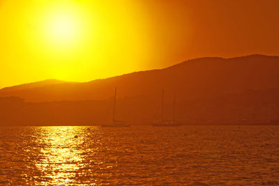 Scenic view of sea against romantic sky at sunset