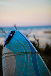 Close-up of blue umbrella on beach