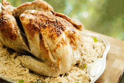 Close-up of roasted chicken in plate on table