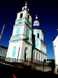 Low angle view of bell tower against blue sky