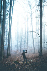 Man standing in forest during winter