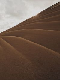 View of sand dunes against sky