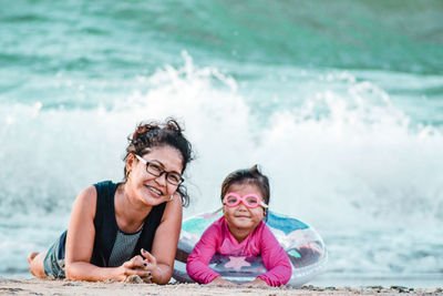 Portrait of smiling girl against water