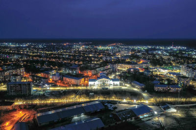 High angle view of illuminated buildings in city at night