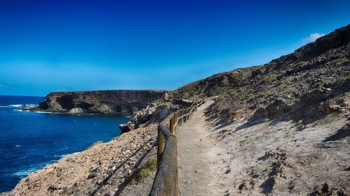 Scenic view of sea against clear blue sky