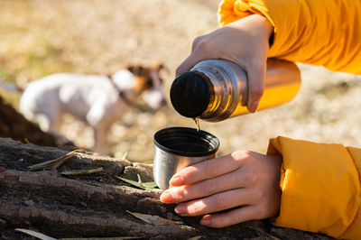 Cropped hand of woman holding bottle