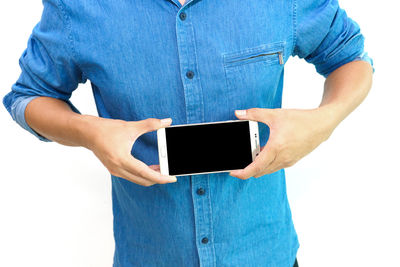 Midsection of man using mobile phone against white background