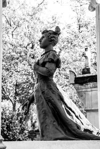 Low angle view of statue against trees