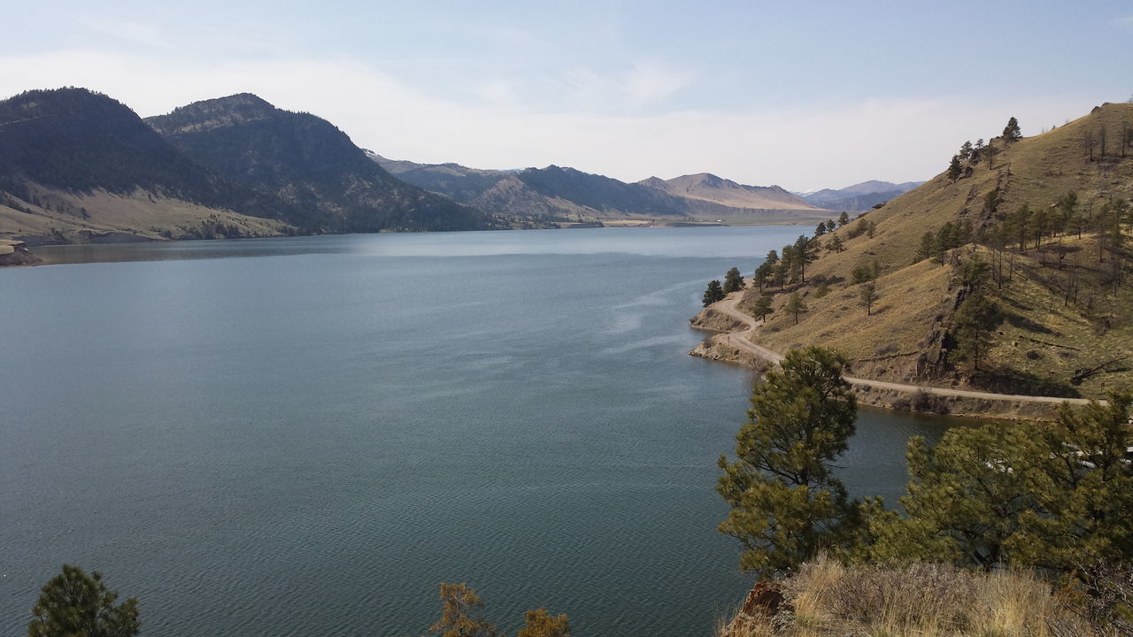 water, mountain, tranquil scene, scenics, tranquility, beauty in nature, mountain range, sea, sky, nature, lake, idyllic, reflection, coastline, calm, non-urban scene, blue, high angle view, outdoors, day