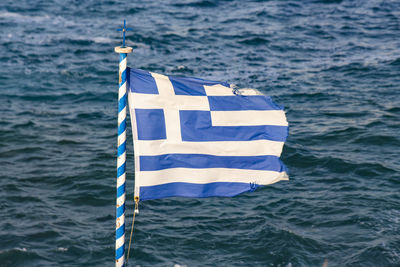 Greek flag against sea