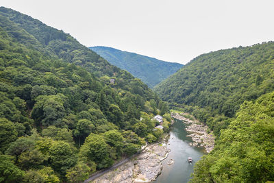 Scenic view of river amidst mountains against sky