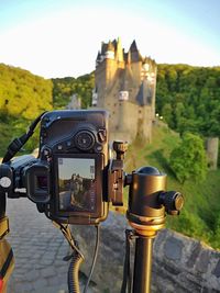 Close-up of camera on tree against sky