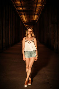 Portrait of young woman standing at parking garage