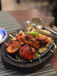 Close-up of roasted chicken in plate on table