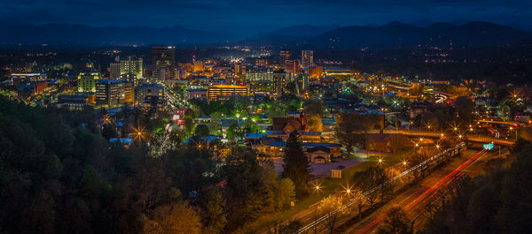 Panoramic shot of illuminated cityscape at night