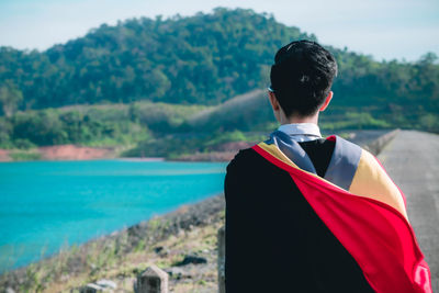 Rear view of man looking at sea