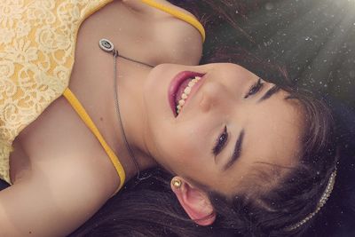 Close-up portrait of young woman in water