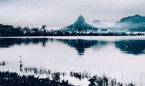 Scenic view of lake against sky during winter