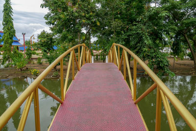 Footbridge amidst trees in park