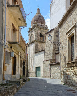 Low angle view of alley amidst buildings in city