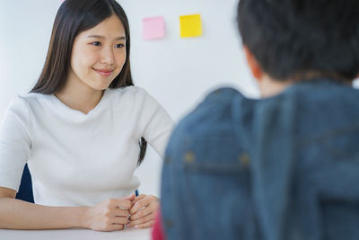 Manager taking interview of young woman at office